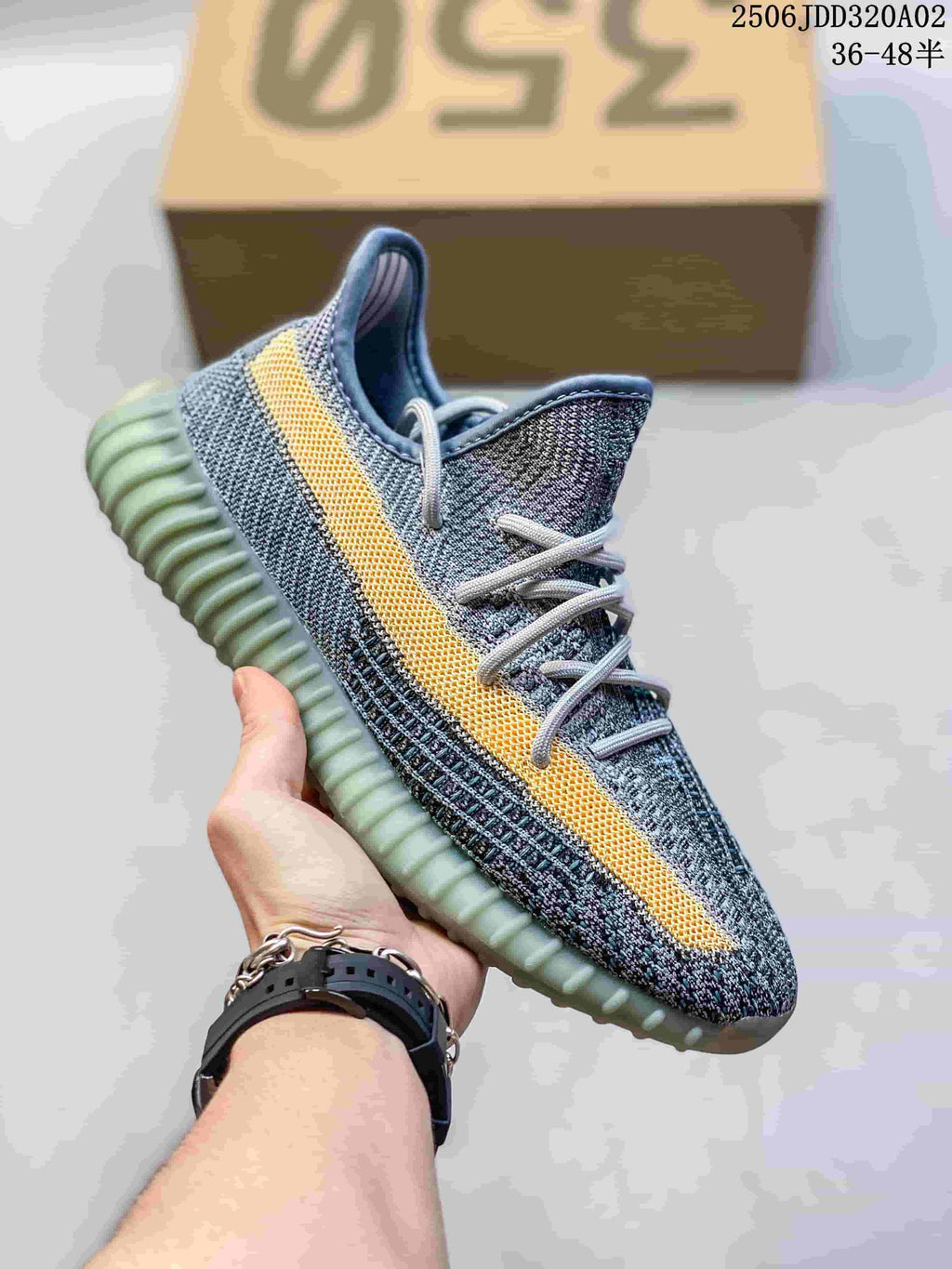 Gray knit low-top sneaker with a yellow side stripe and pale green ribbed sole