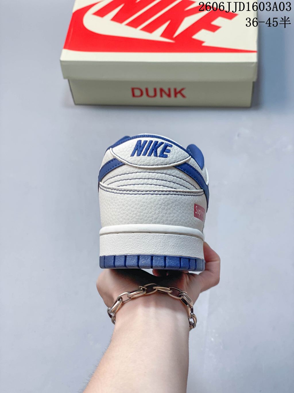 Rear view of a white and blue low-top sneaker