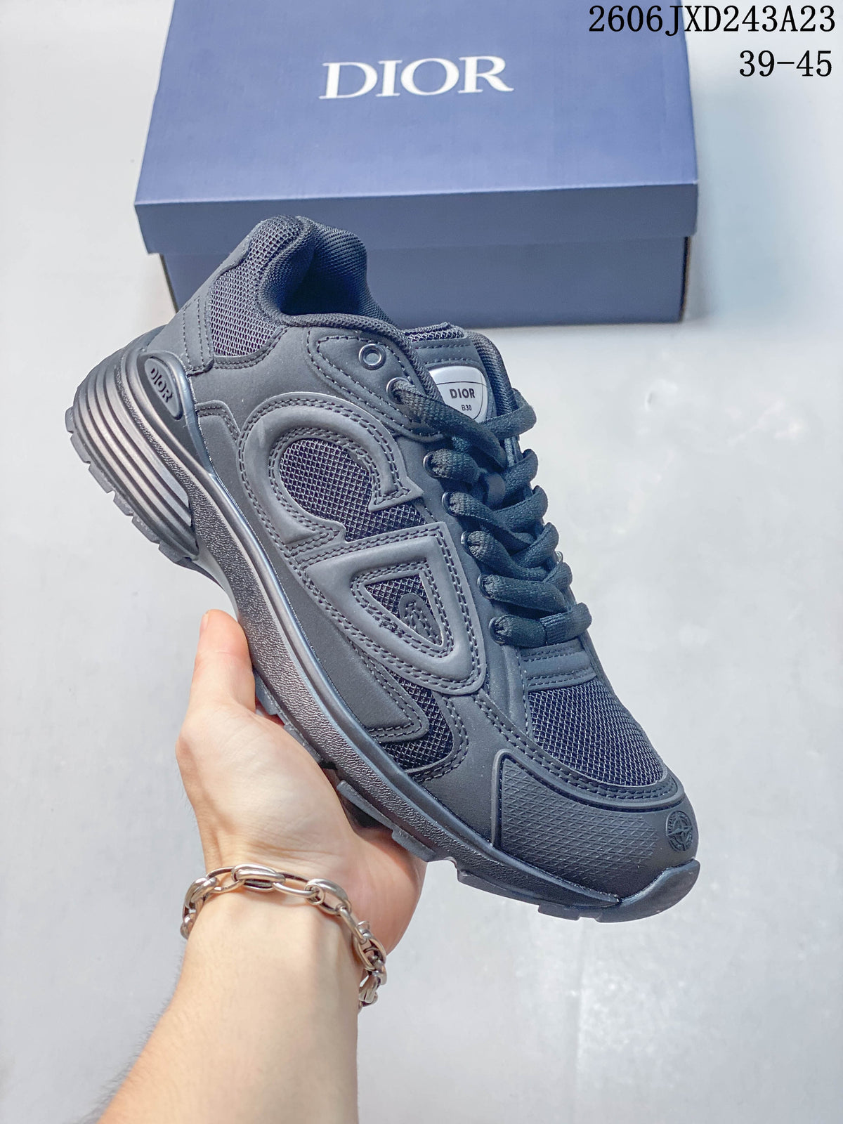 Charcoal low-top sneaker with matching dark mesh panels and lace-up closure.