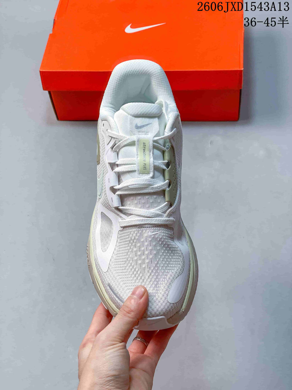 Top view of the lace-up Nike Structure Plus shoe with its tongue label visible