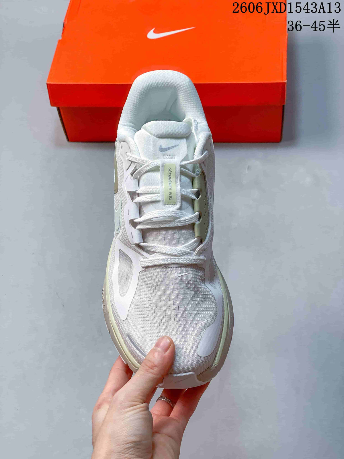 Top view of the lace-up Nike Structure Plus shoe with its tongue label visible