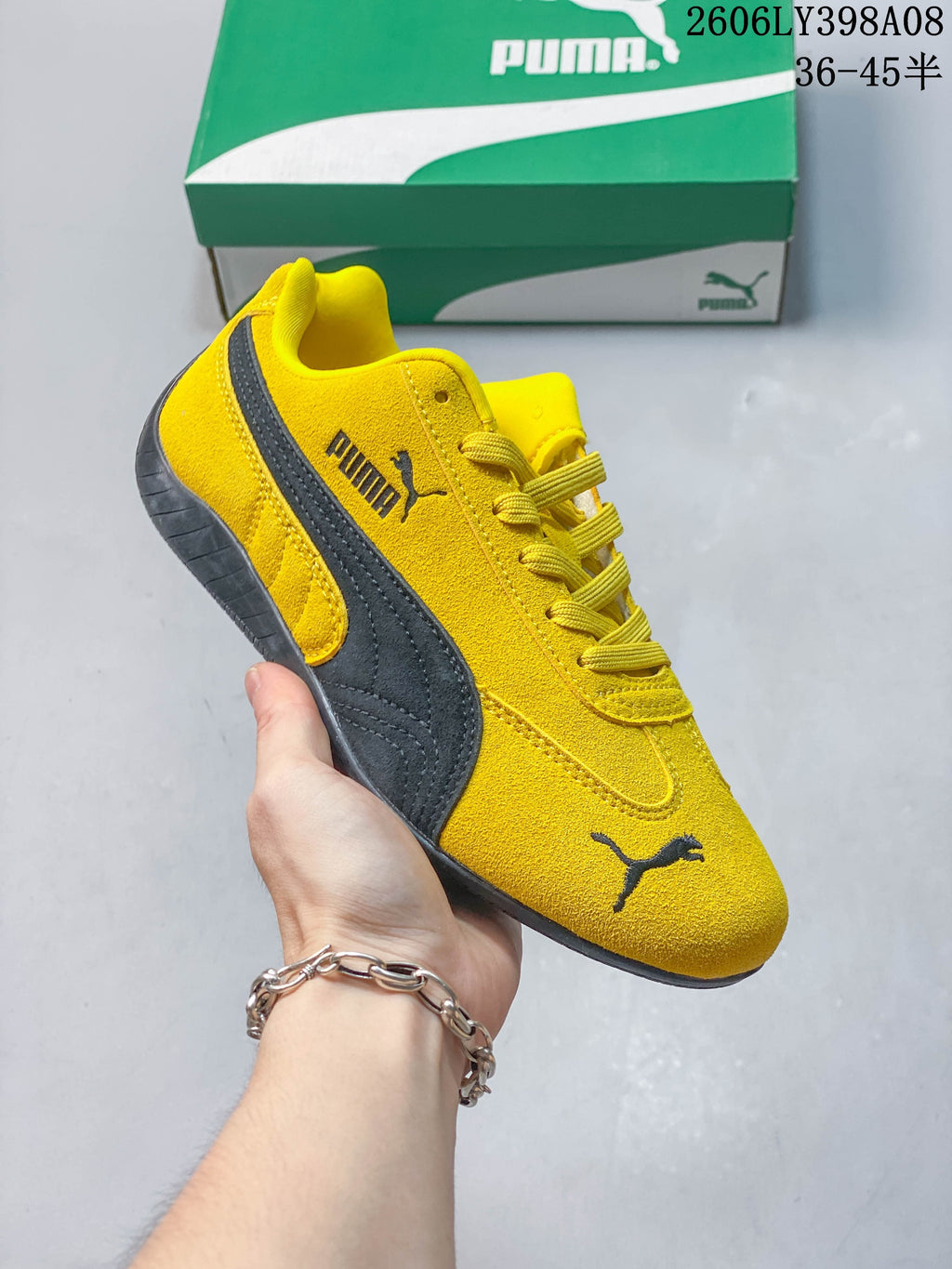 Close-up of a yellow PUMA Speedcat OG sneaker with dark side stripe