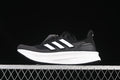 Side view of a black Adidas Ultraboost 5 shoe with white stripes and a white midsole