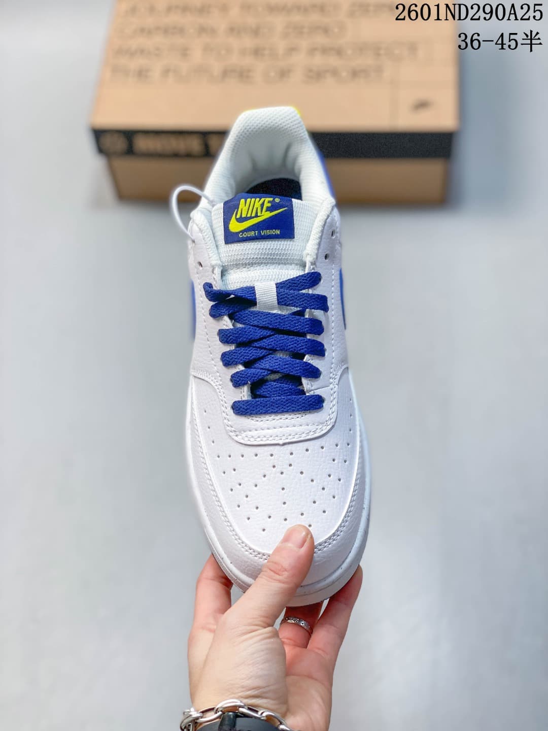 Front view of the sneaker showing blue laces, a perforated toe, and a branded tongue.