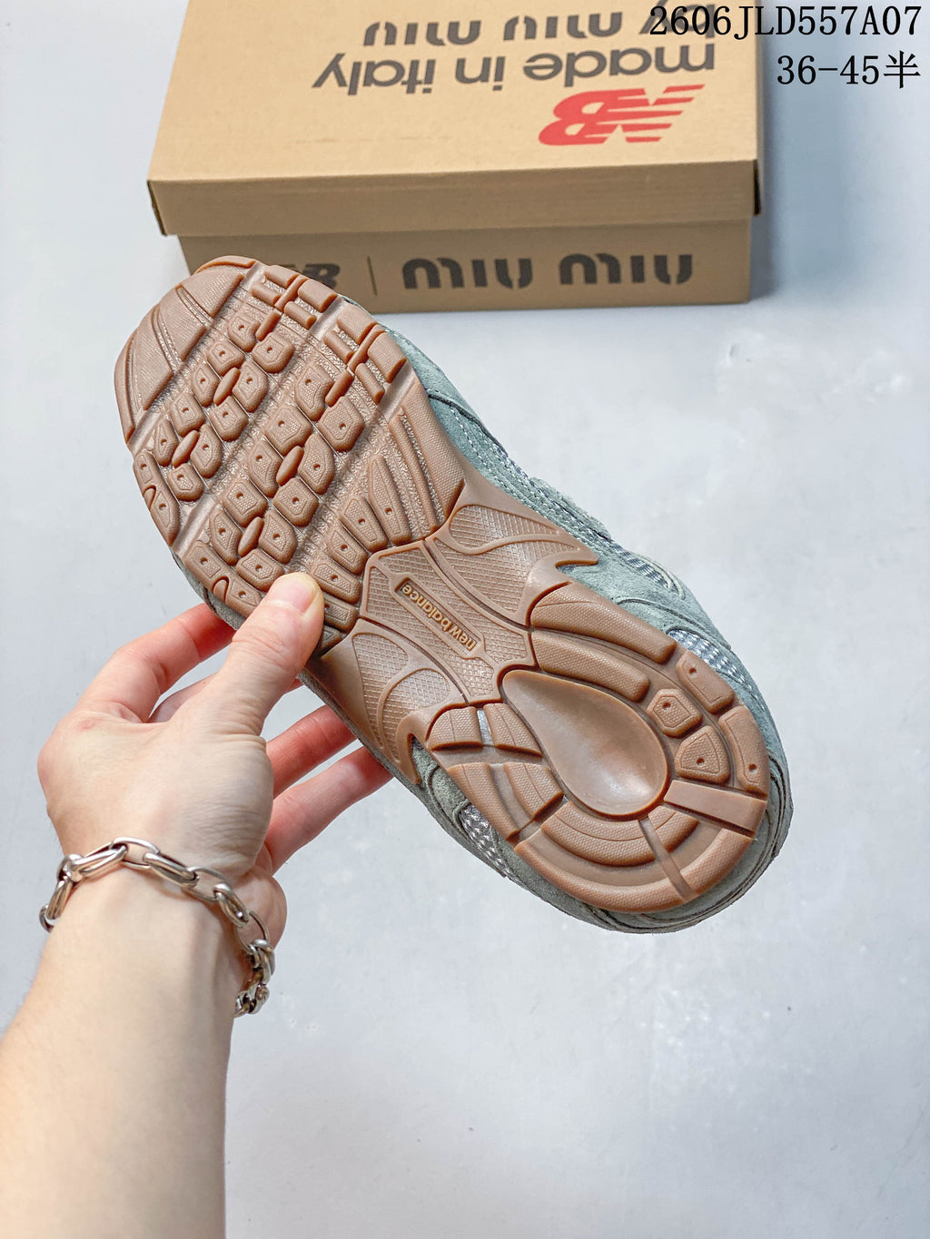 Close-up of the gum-tone outsole on a sage-green and silver New Balance 530 SL sneaker