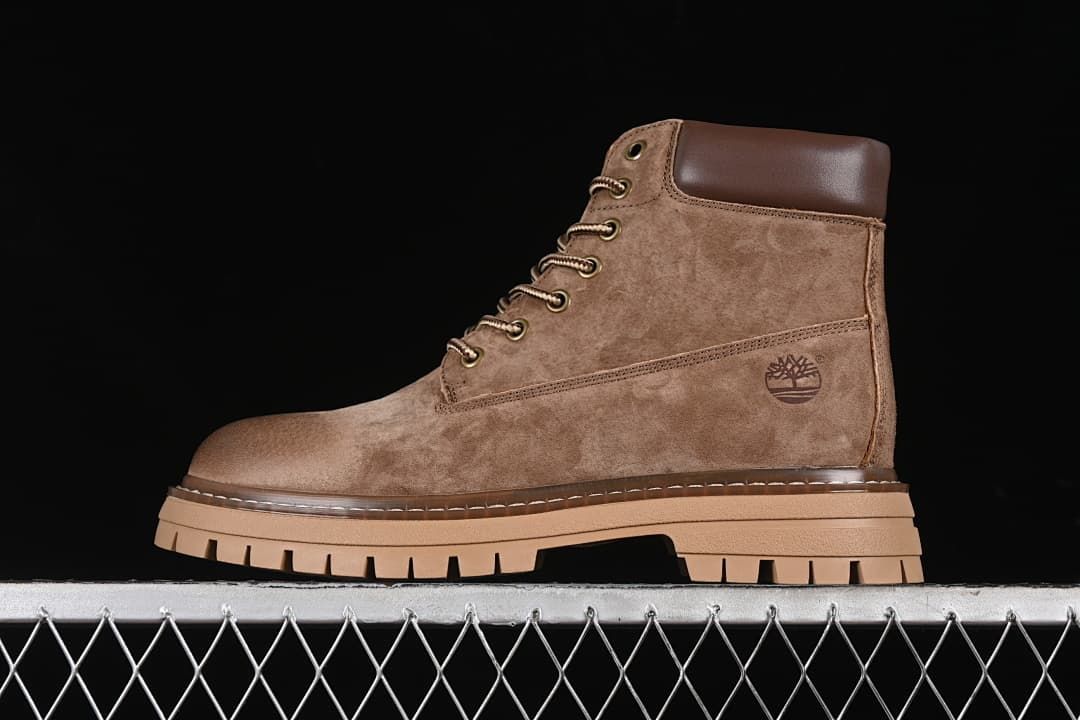 Side profile of a khaki-brown Timberland lace-up boot with a tan lugged sole