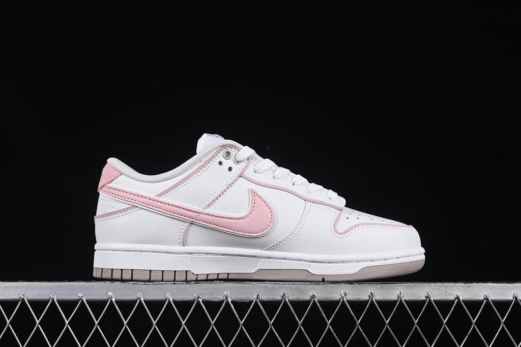 Side profile of a white and pink sneaker