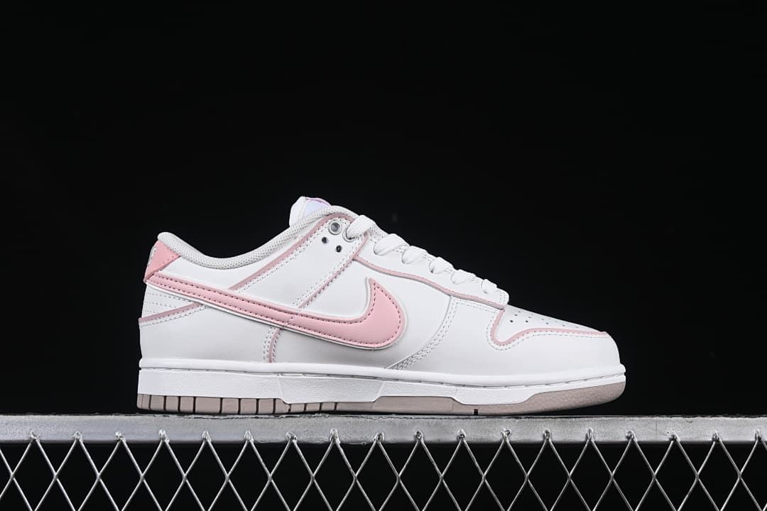 Side profile of a white and pink sneaker