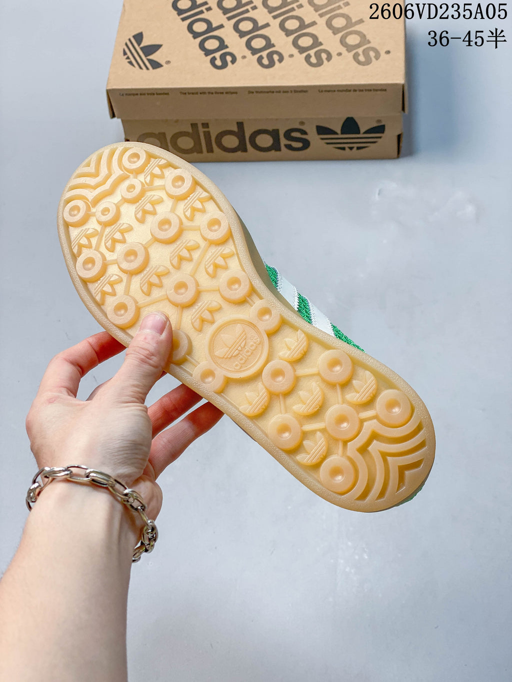 Close view of the gum-colored outsole on the green adidas Samba sneakers.