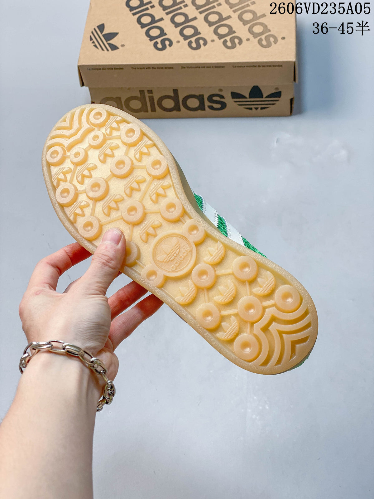 Close view of the gum-colored outsole on the green adidas Samba sneakers.