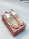Pair of light beige loafers shown from above on a box