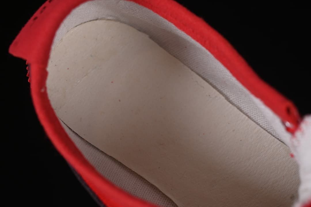 View inside the red sneaker showing its lining and insole
