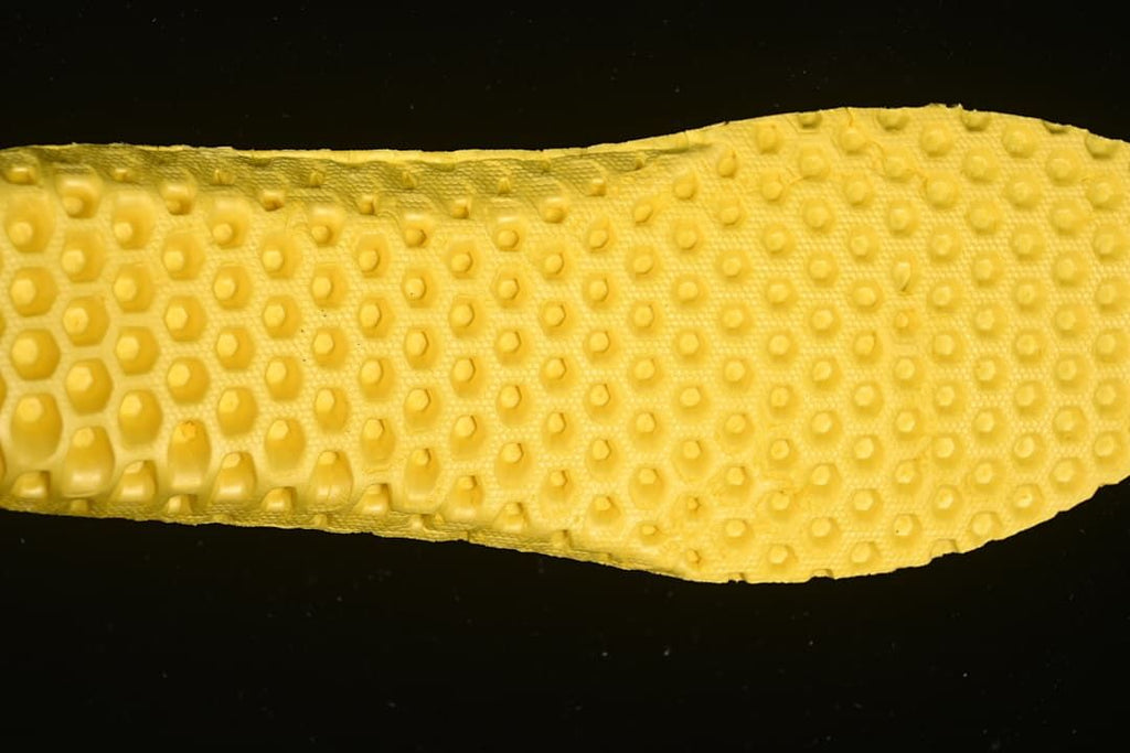 Close-up of the sneaker's yellow outsole tread.