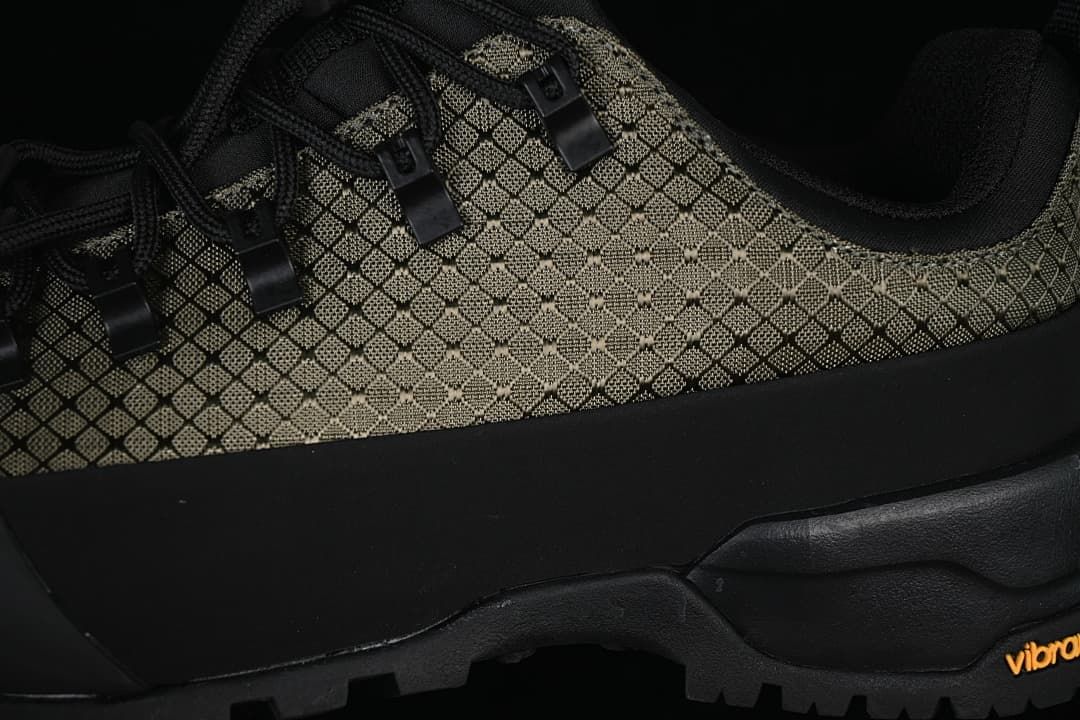 Close-up of the patterned upper, lace hooks, and treaded sole