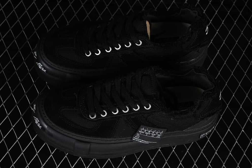 Pair of black low-top platform sneakers viewed from above