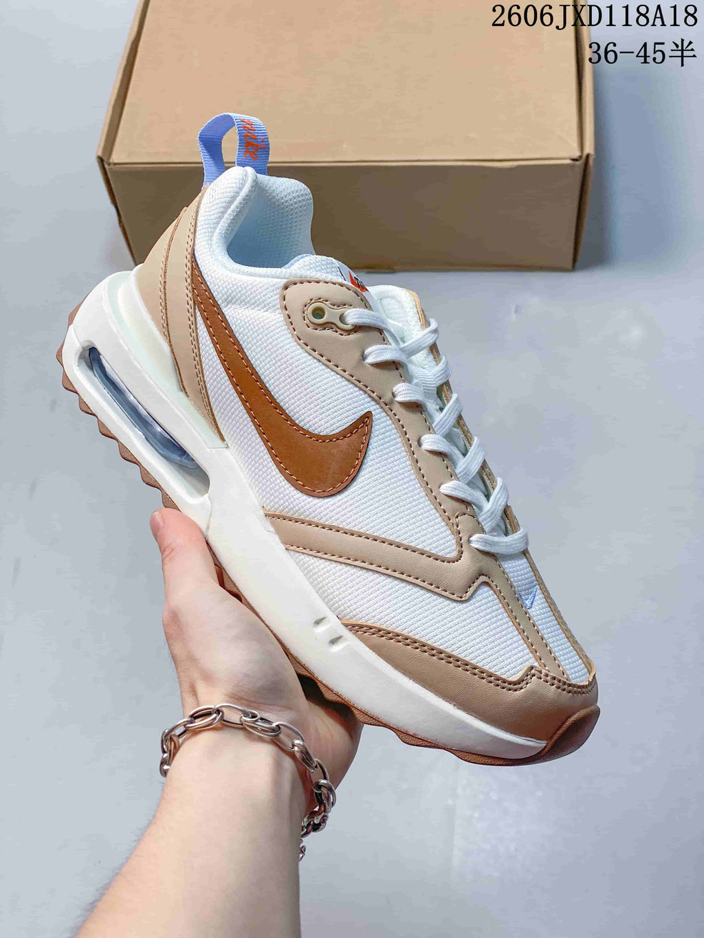 White Nike Air Max Dawn sneaker with tan and brown accents