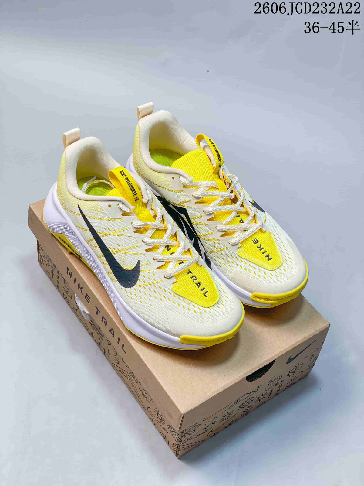Pair of light Nike Wildhorse 10 trail-running shoes with yellow and dark accents.