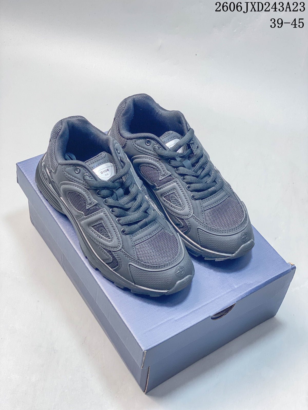 Pair of charcoal gray Dior B30 low-top sneakers displayed on a box