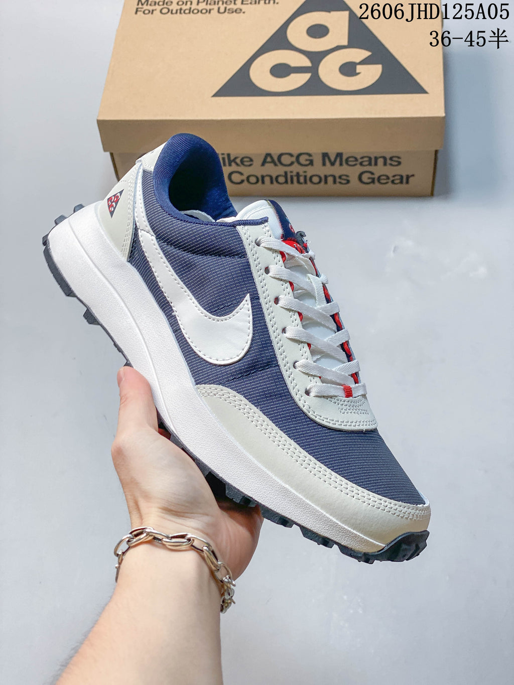 Side view of navy and white Nike ACG LDV sneaker with a lugged outsole