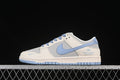 Side view of a cream, grey, and light-blue low-top sneaker with a blue swoosh and heel branding.
