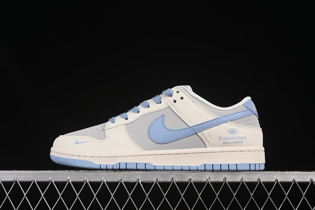 Side view of a cream, grey, and light-blue low-top sneaker with a blue swoosh and heel branding.