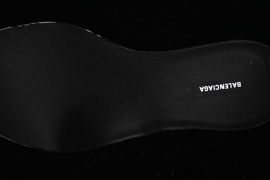 Close-up of the dark insole with printed branding.