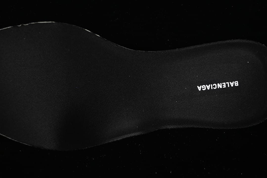 Close-up of the dark insole with printed branding.