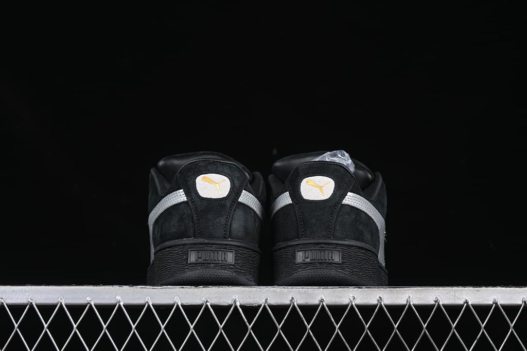 Rear view of both sneakers showing silver heel stripes and black soles.