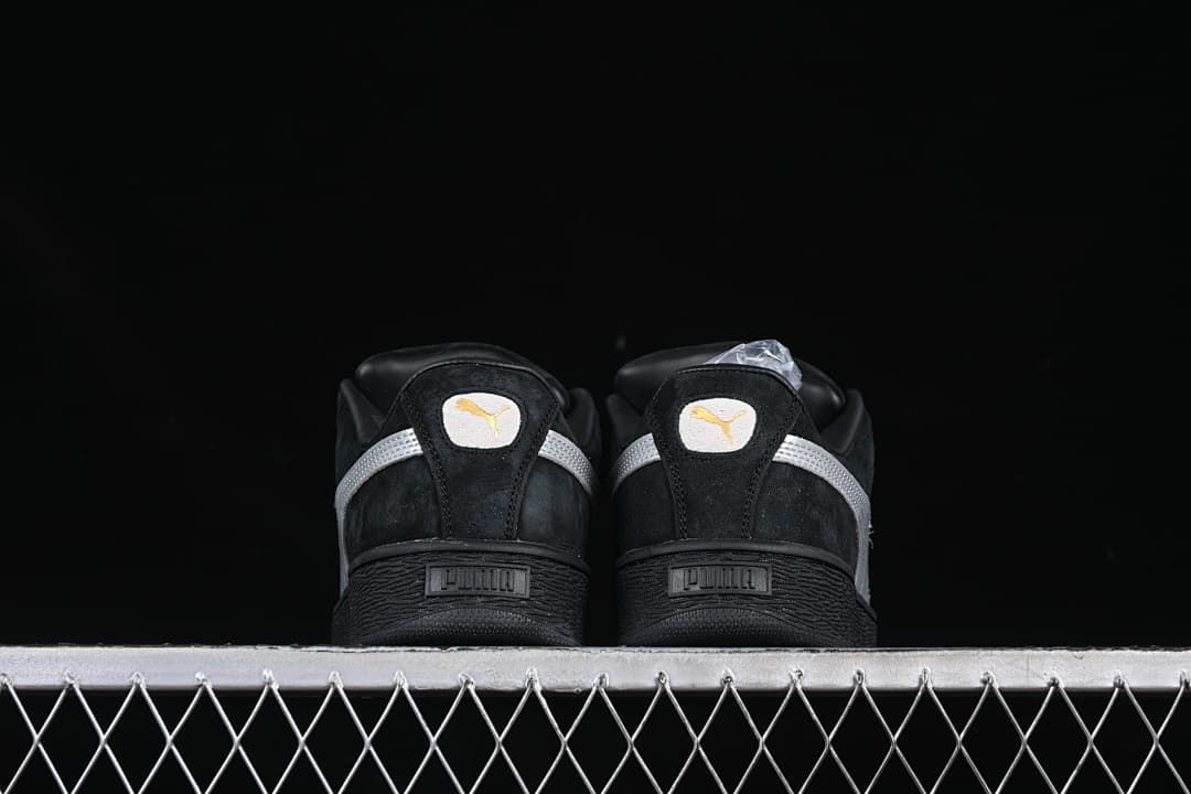 Rear view of both sneakers showing silver heel stripes and black soles.