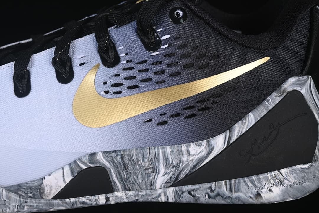 Close-up of gold Swoosh and marbled side sole