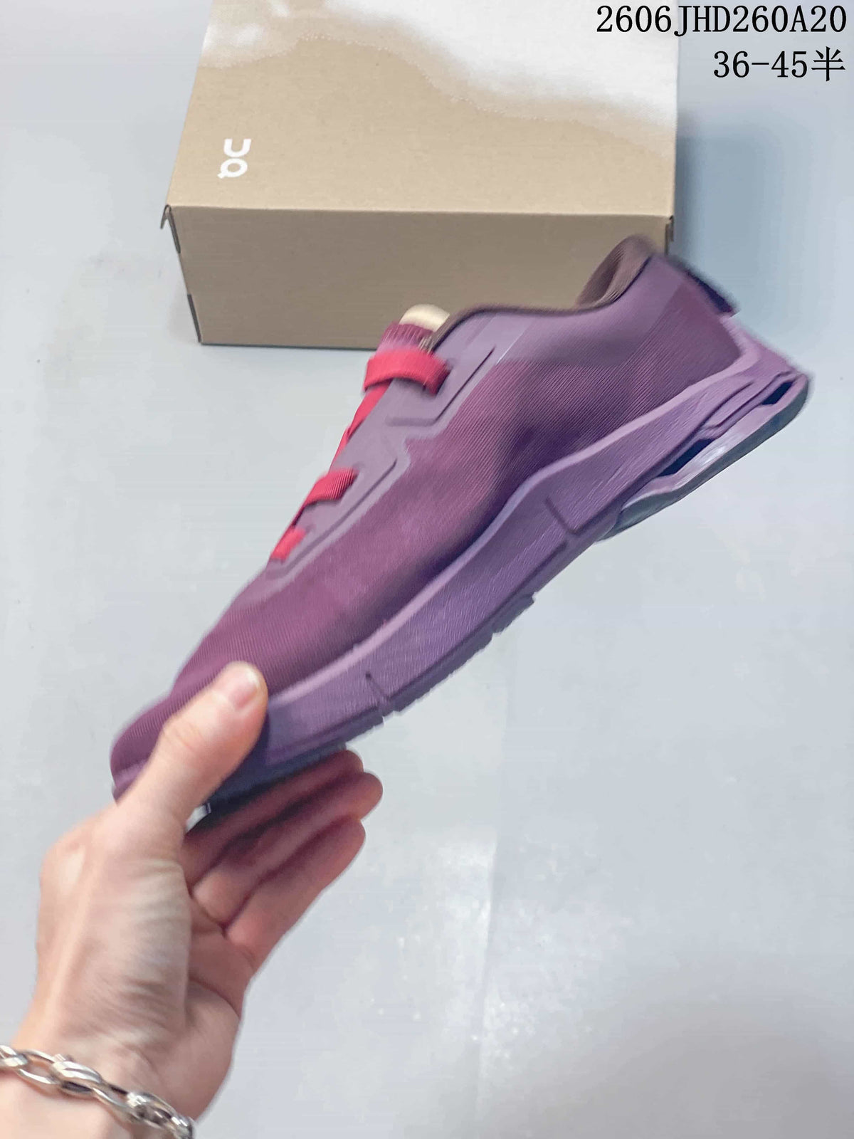 Side profile of the purple low-top shoe with red lace bands