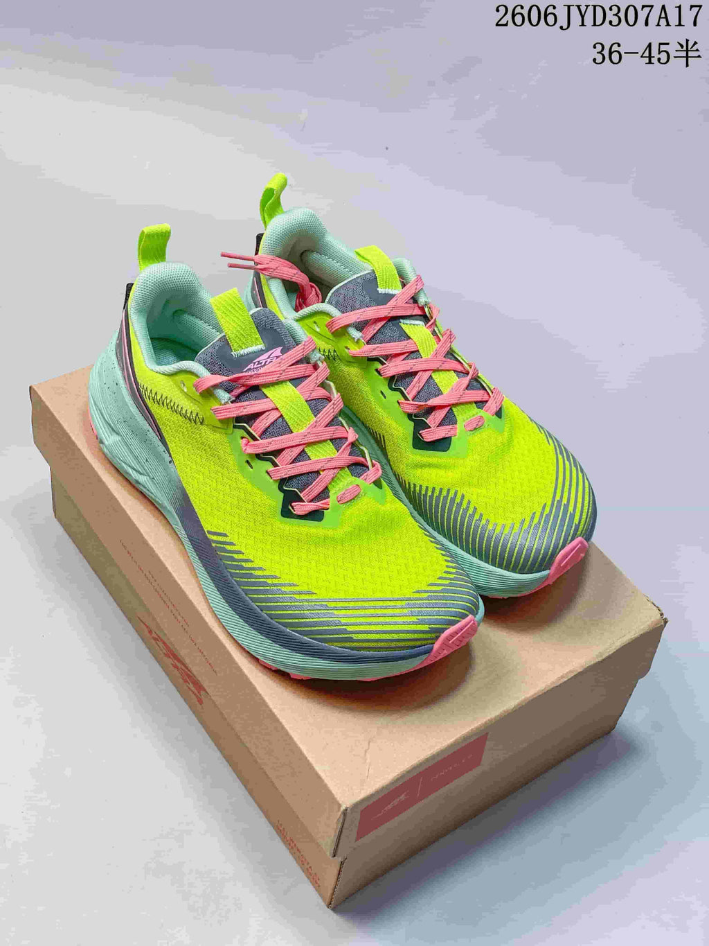 Pair of Altra Experience Wild 2 running shoes in lime green, aqua, gray, and pink, shown with a box; image text lists sizes 36–45.5.