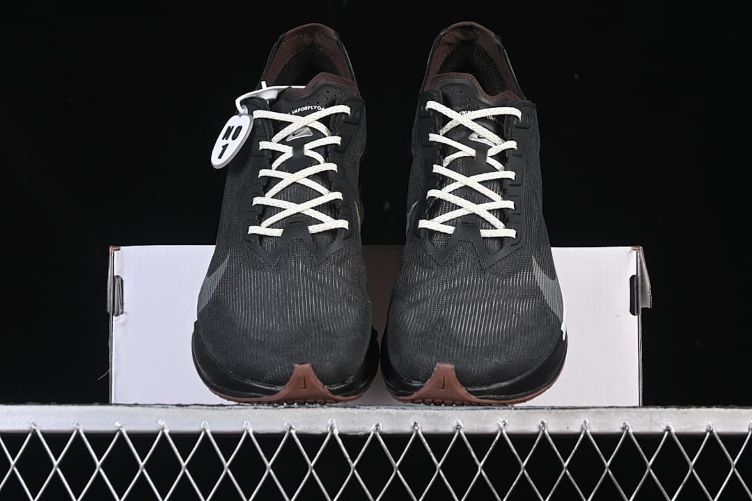 Front view of the pair showing their dark uppers and light-colored laces.
