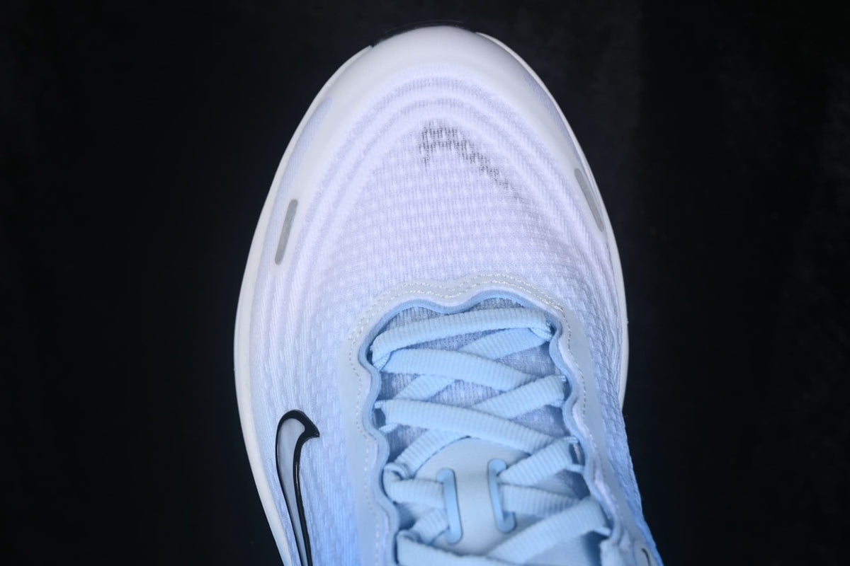 Close-up of the textured white toe box, laces, and small black Swoosh detail.