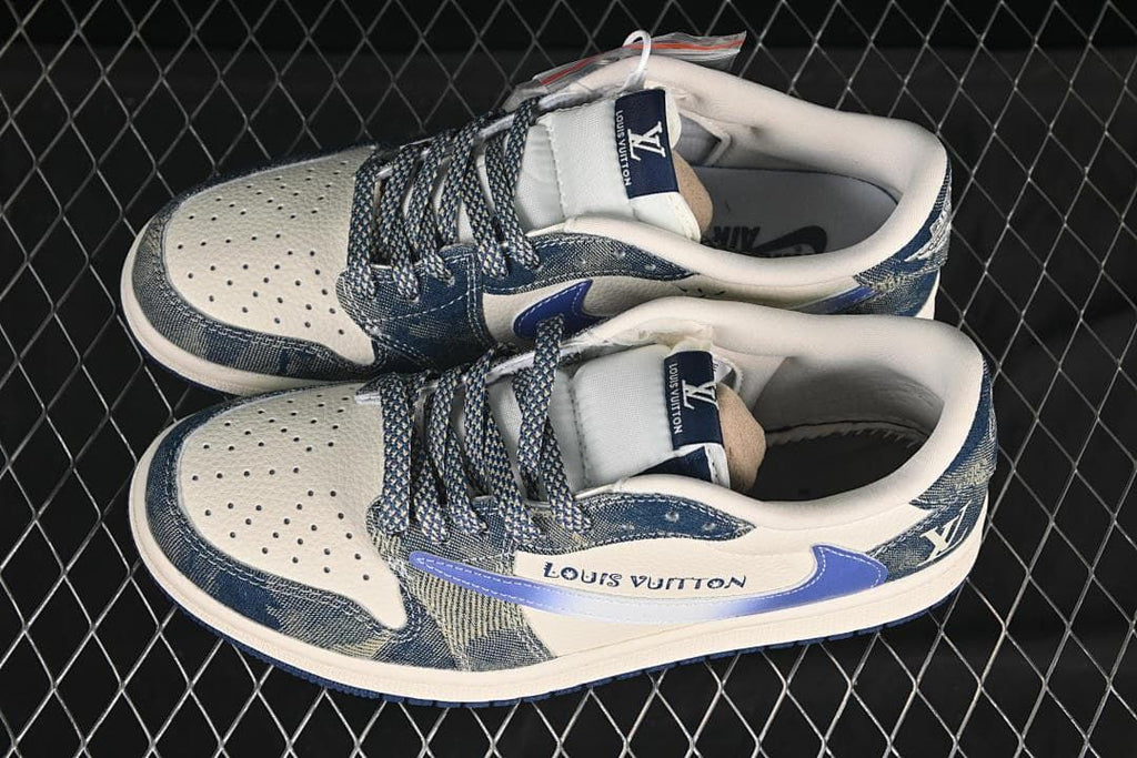Overhead view of a pair of cream and blue low-top sneakers with patterned laces and denim-style panels
