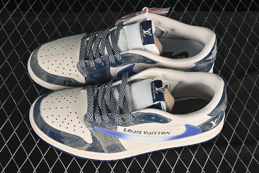 Overhead view of a pair of cream and blue low-top sneakers with patterned laces and denim-style panels
