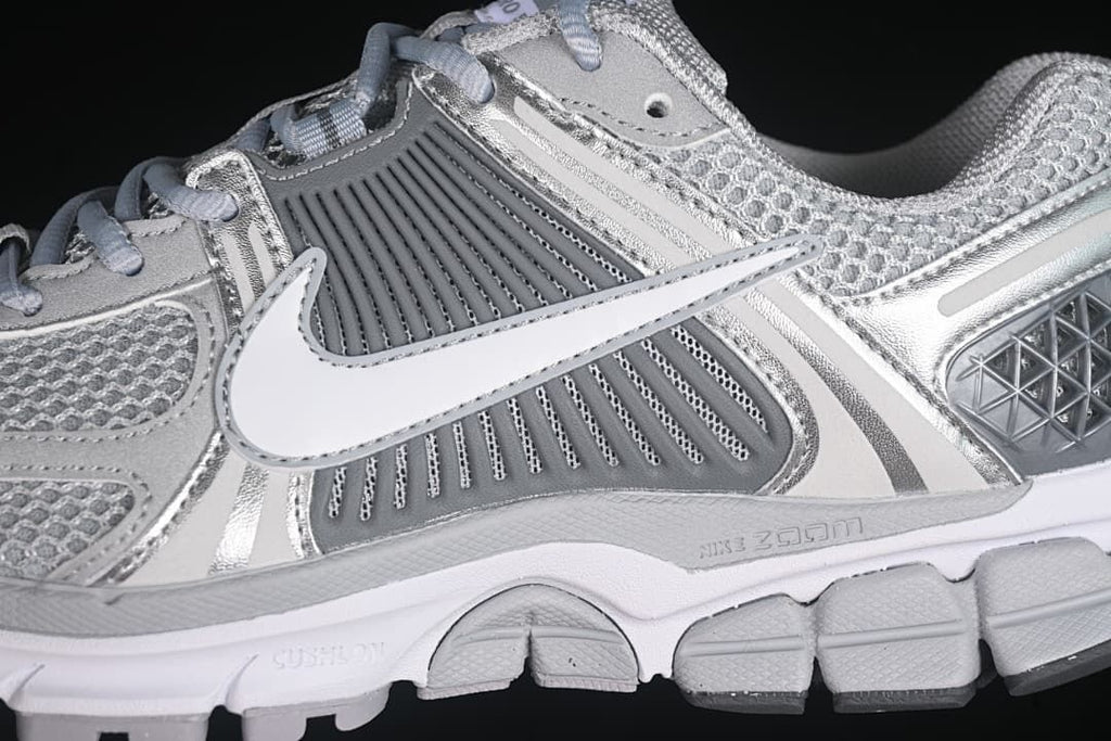 Side detail showing the Swoosh, layered panels, and midsole
