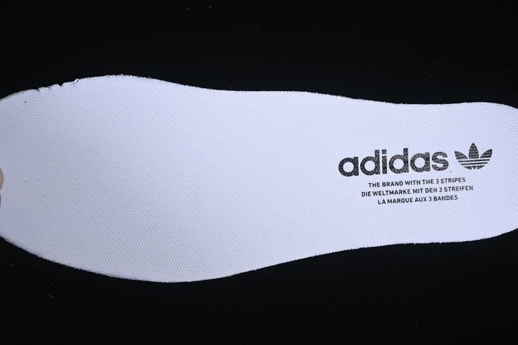 Close-up of a white insole with adidas branding.