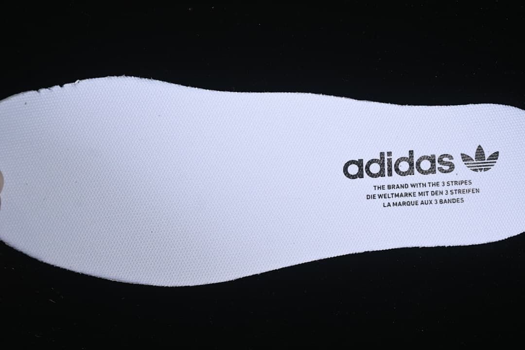 Close-up of a white insole with adidas branding.