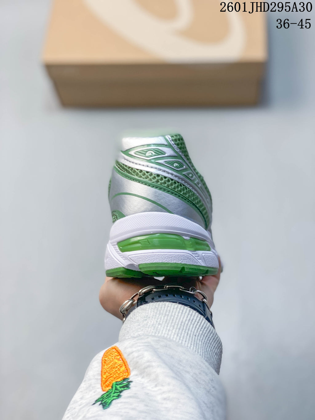 Rear view showing the green and silver heel and white midsole.