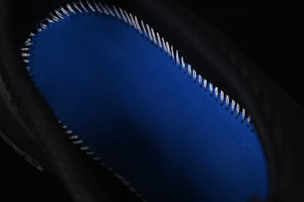 Close-up of the blue footbed inside the black mule