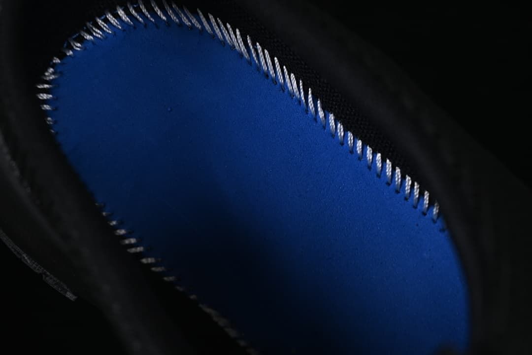 Close-up of the blue footbed inside the black mule