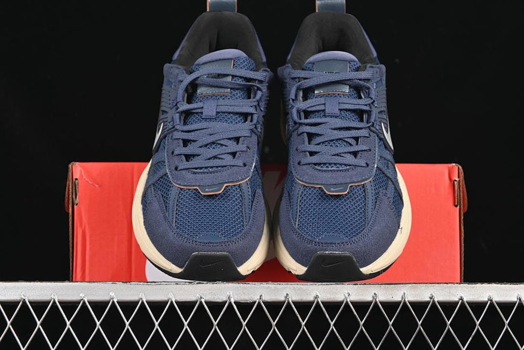 Front view of the pair of navy lace-up sneakers