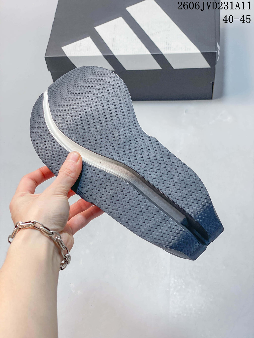 Close-up of the textured gray outsole on an Adidas Adizero Dropset Elite shoe