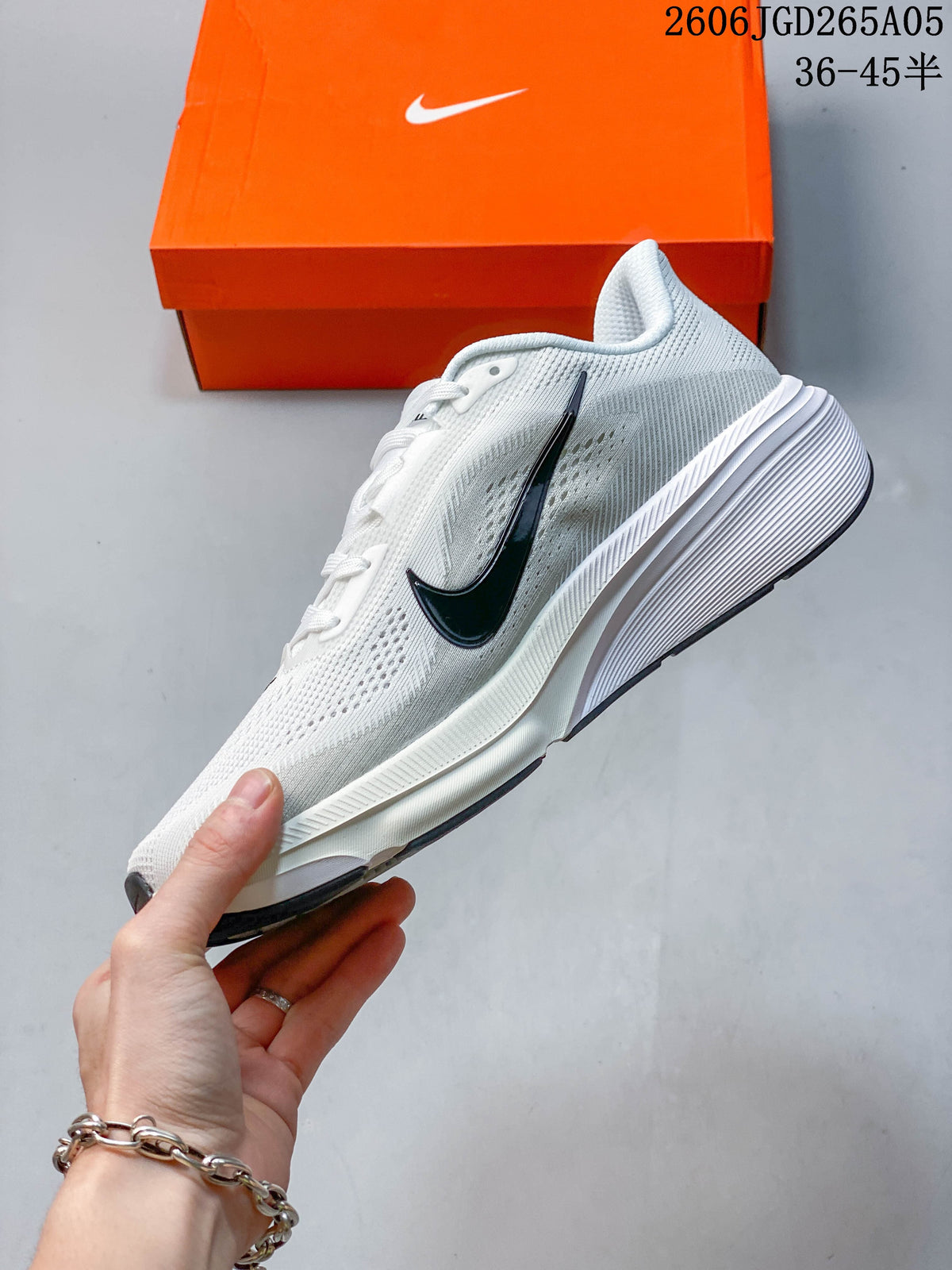 Side profile of a white Nike Pegasus 42 running shoe with a dark Swoosh