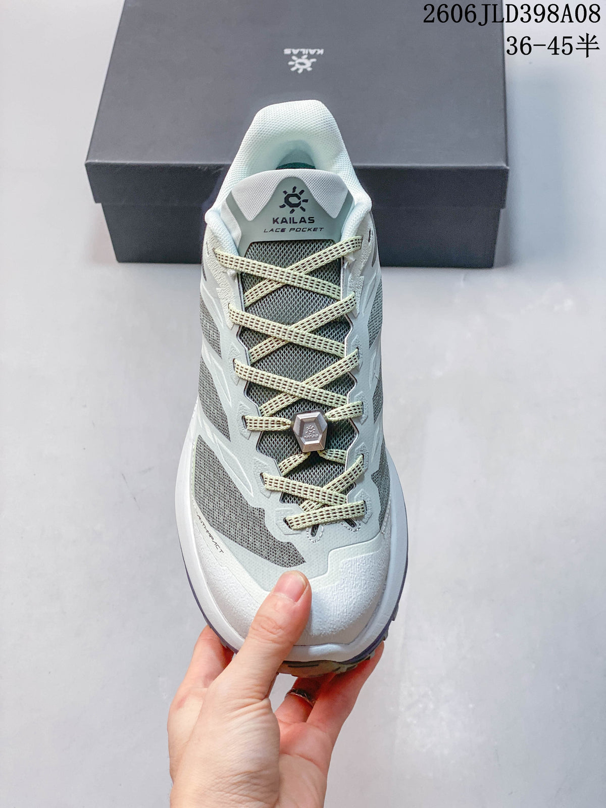 Top view of the shoe showing its laces, tongue lace pocket, and gray mesh panels