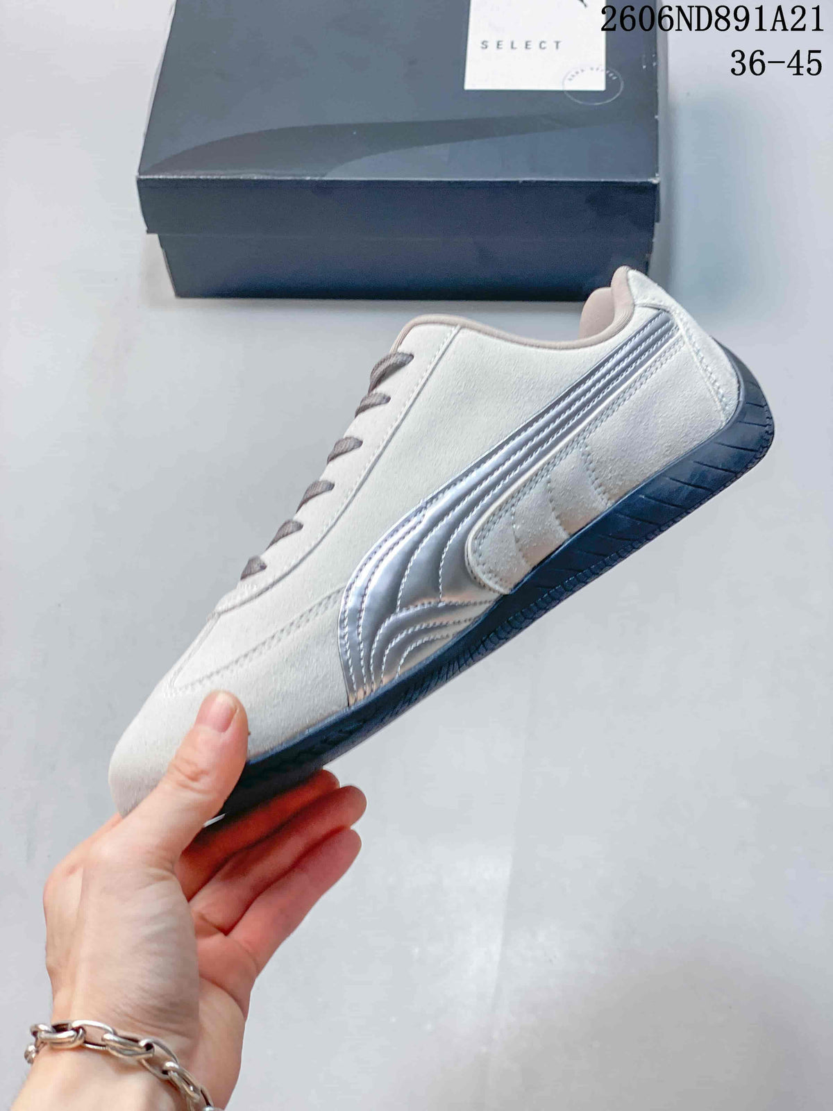 Side profile of a light gray Puma Speedcat OG sneaker with silver stripes and a dark outsole