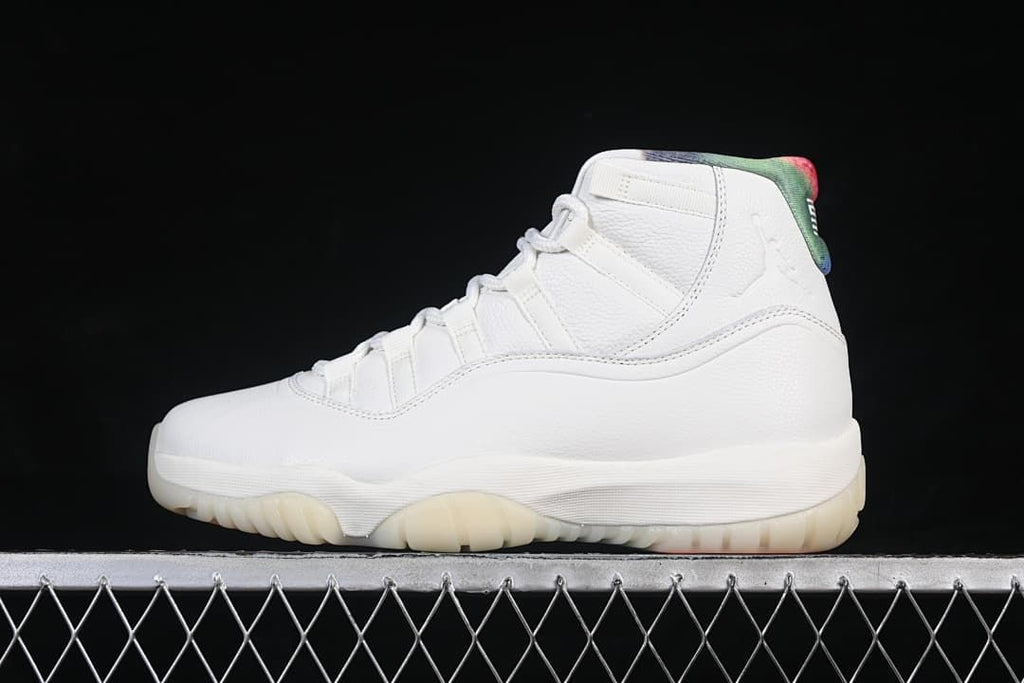 Side view of a white Air Jordan 11 Retro high-top sneaker with colorful collar accents.