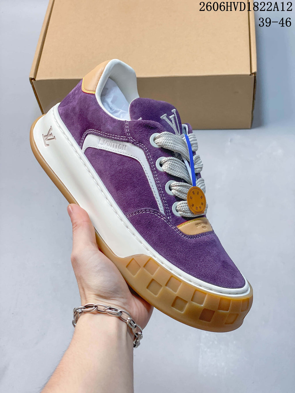 Angled side view of a purple sneaker showing its white side panel and gum-colored outsole.