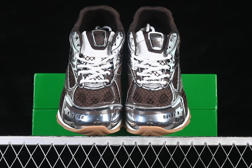 Front view of the pair showing brown mesh-patterned panels, silver-tone toe details and tan outsoles.